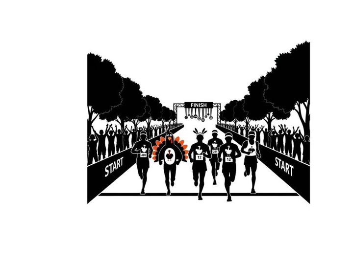 Runners in silhouette approach finish line with crowd and trees