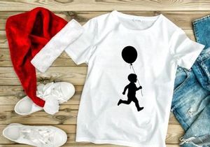 Silhouette of a child running with a balloon, joy, freedom