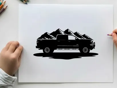Silhouette of a pickup truck in front of mountains