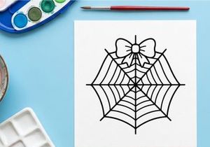 Hand-drawn Halloween spider web with bow. Classic black and white cobweb illustration for festive decor.