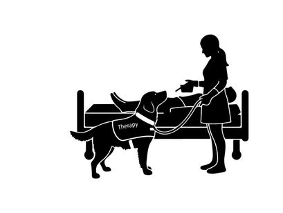 Silhouette of woman and service dog assisting person in bed