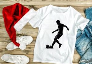 Silhouette of a soccer player kicking a ball in action