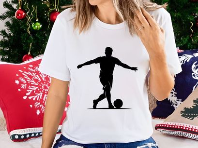 Silhouette of a soccer player kicking a ball in a dynamic pose
