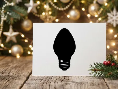 Black silhouette of a classic light bulb isolated on a white background.