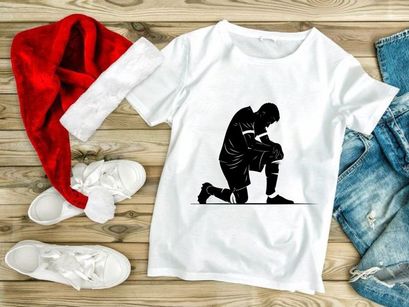 Soccer player kneeling on one knee in contemplation or injury assessment