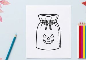 Halloween trick or treat candy bag with jack-o-lantern face. Festive paper sack for collecting sweets and spooky party favors.