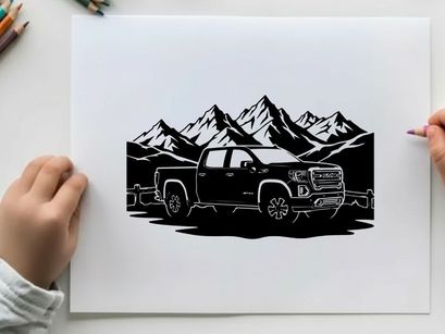 Silhouette of a pickup truck in front of mountains