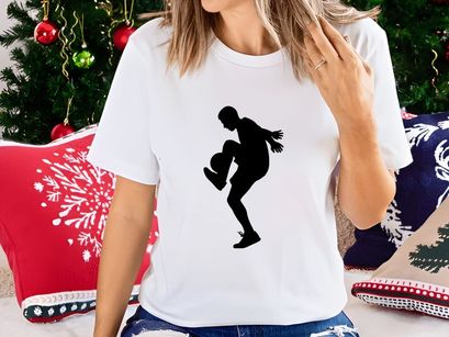 Silhouette of a female soccer player kicking a ball with dynamic movement