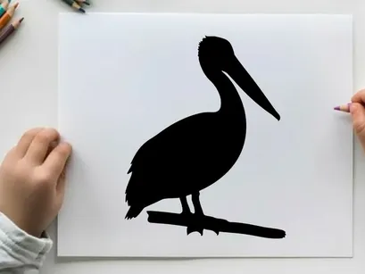 Silhouette of a pelican bird standing on a branch