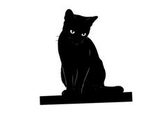 Black cat silhouette sitting on a platform looking forward