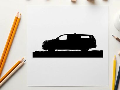 Silhouette of a car in front of mountains