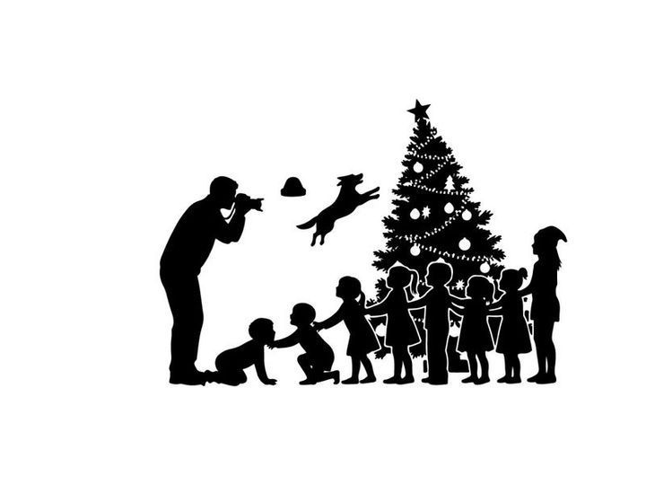 Christmas silhouette of family decorating tree with children and dog