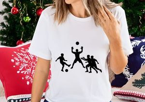 Silhouette of four men playing soccer or football with ball