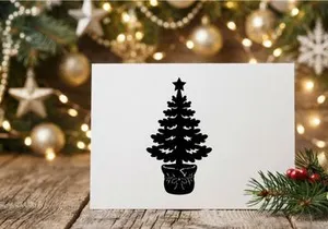 Black silhouette of a Christmas tree in a pot with a star topper on white background
