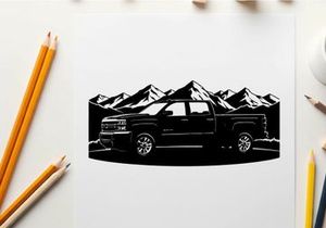 Silhouette of a pickup truck in front of mountains