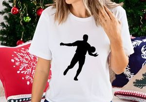 Silhouette of a man playing soccer or football with a ball