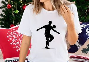 Silhouette of a soccer player kicking a ball in mid air motion