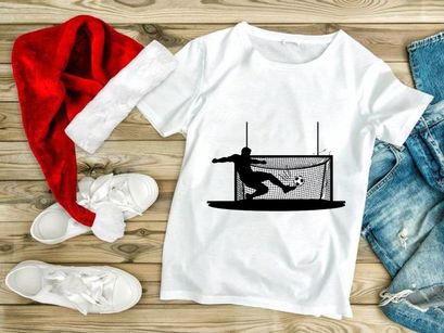 Soccer player kicking ball into goal net in action