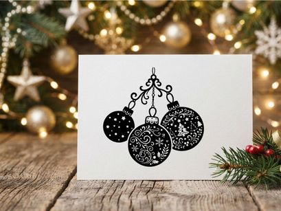 Black and white Christmas bauble ornaments hanging on a decorative scroll flourish.