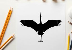 Silhouette of a bird with outstretched wings in flight