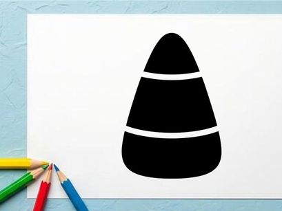 Close-up of a black and white candy corn on white background