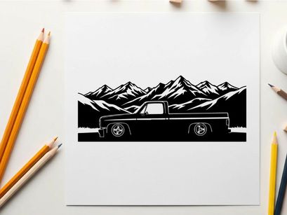 Silhouette of a pickup truck in front of majestic mountain range silhouette