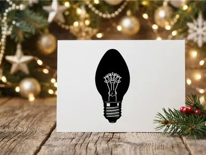 Black and white silhouette of a classic incandescent light bulb icon