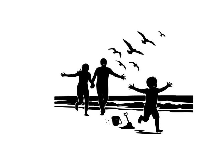 Family silhouette running on beach with seagulls flying overhead