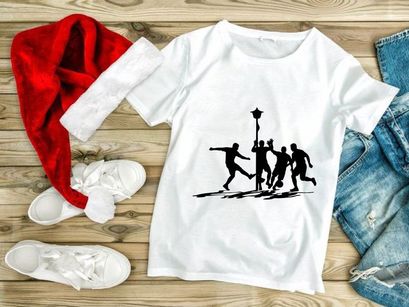 Silhouette of four men playing soccer around a streetlamp on a field