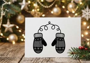 Black and white hand drawn illustration of a pair of cozy winter mittens with snowflakes.