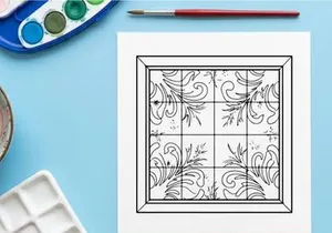 Christmas window decal with snowflake and floral swirl patterns on a glass pane