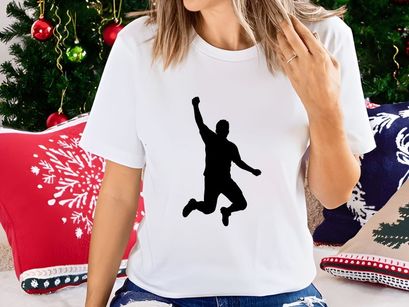 A silhouette of a person jumping in the air with one arm raised