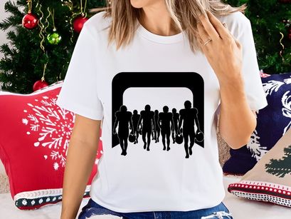 Silhouette of football players walking through an archway with bags