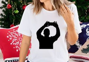 A person forming a frame with their hands in a black silhouette