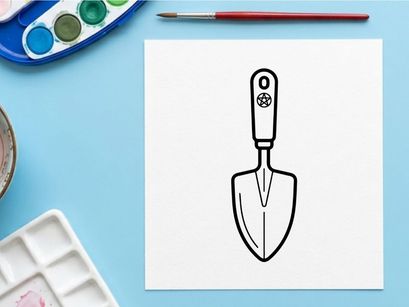 Hand holding vintage silver garden trowel with floral engraving. Classic stainless steel digging tool for planting and gardening tasks.