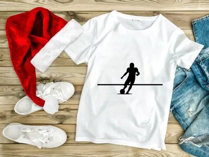 Silhouette of a soccer player kicking a ball in motion