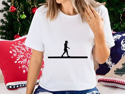 Silhouette of a woman walking alone on a plain background