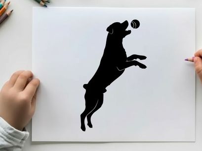 Dog silhouette jumping to catch a ball in mid air silhouette