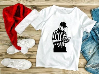 A referee in a black and white striped shirt checking a mobile phone