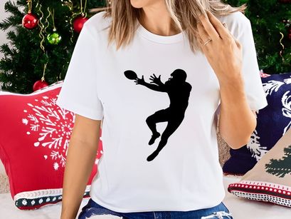 American football player catching a ball in mid air silhouette