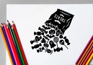 Black and white coffee bag spilling coffee beans with flowers and spoon