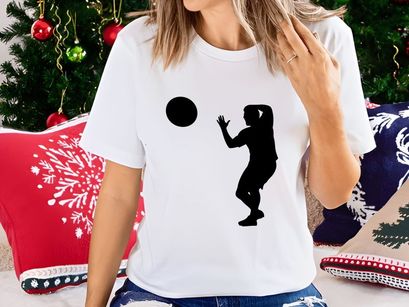 A silhouette of a person catching a ball in mid air with athletic movement and focus