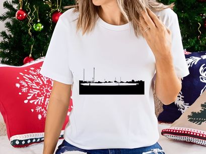 A black and white landscape photograph of a foggy scene with silhouetted structures