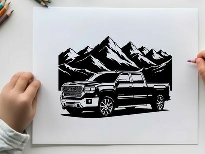 Silhouette of a pickup truck in front of mountains