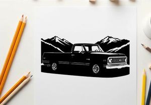 Silhouette of a classic pickup truck against mountain range silhouette
