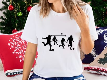 Silhouette of soccer players in action kicking balls near a goal