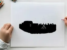 Silhouette of people gathered around campfire with vehicle silhouette