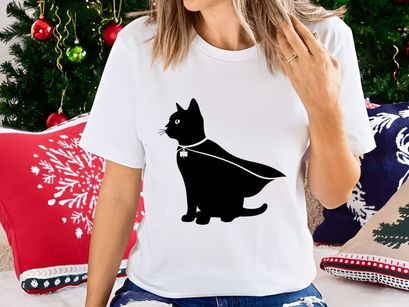 Black cat in cape and shamrock charm