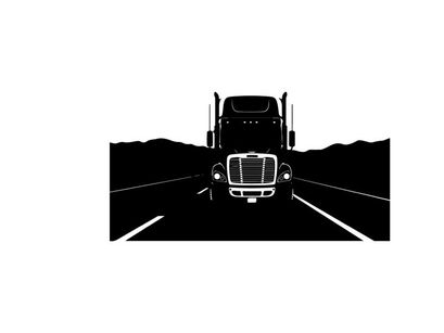 Silhouette of a semi truck driving on a highway