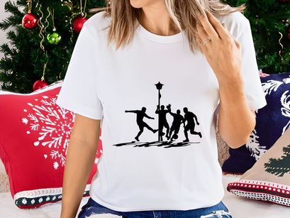 Silhouette of four men playing soccer around a streetlamp on a field